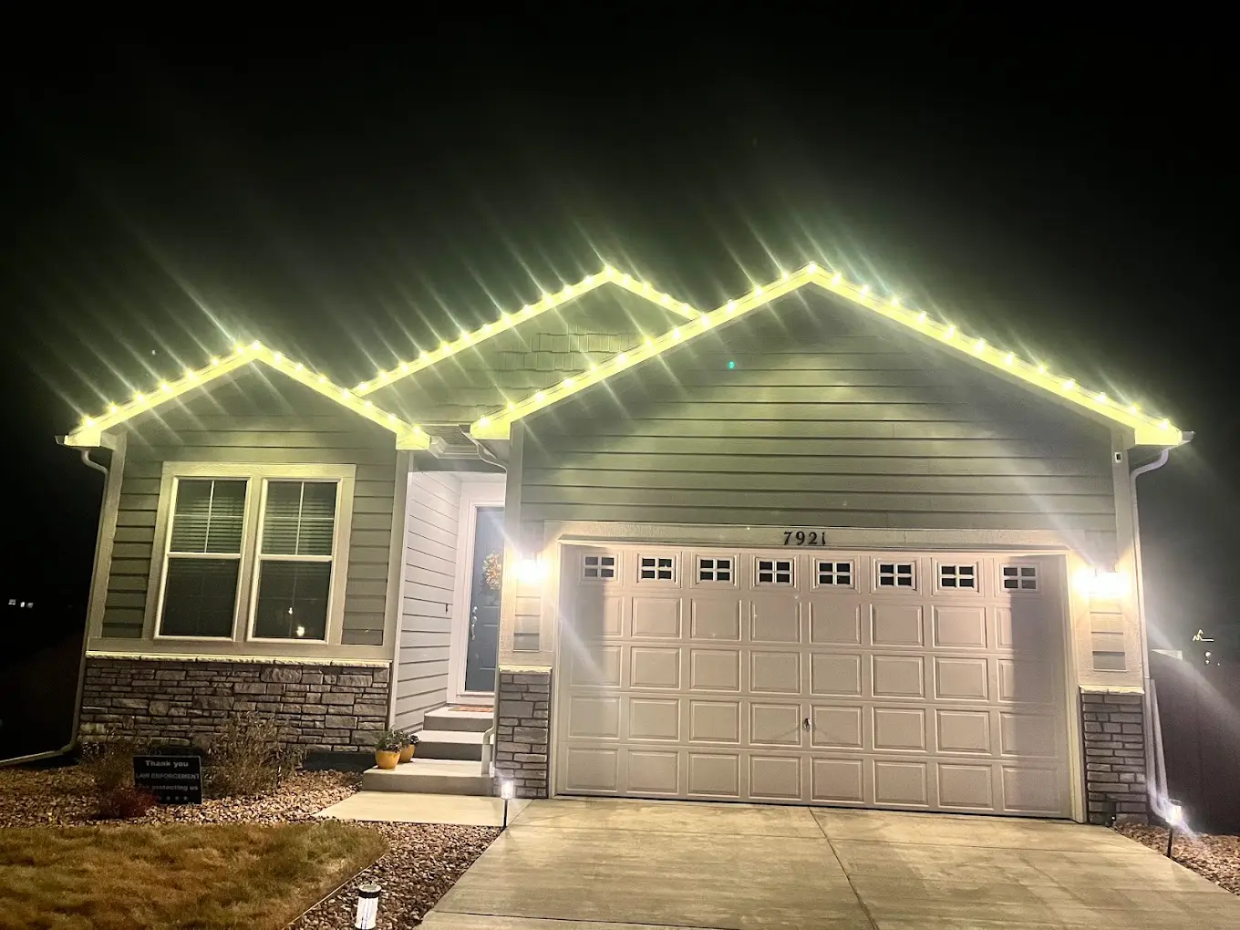 Warm white Christmas lights installation Colorado Springs - elegant LED roofline lighting on single-family home, professional holiday display with clean modern aesthetic